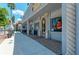 Exterior of a blue building with architectural details, shops, and outdoor seating with sidewalk at 23590 Copperleaf Dr, Venice, FL 34293