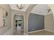 Hallway with arched entryway leading into open concept living area overlooking the lake at 23590 Copperleaf Dr, Venice, FL 34293