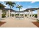 Relaxing hot tub area with pergola, lounge chairs, and well-maintained landscaping at 23590 Copperleaf Dr, Venice, FL 34293