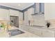 Beautiful kitchen features stainless steel appliances, granite countertops, modern cabinetry, and a stylish backsplash at 23590 Copperleaf Dr, Venice, FL 34293