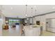 Open concept kitchen featuring an island with granite countertops and stainless steel appliances at 23590 Copperleaf Dr, Venice, FL 34293