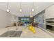 Spacious kitchen area opens to the living room, featuring a large island with a sink and modern appliances at 23590 Copperleaf Dr, Venice, FL 34293