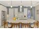 Bright kitchen with a large island, stainless steel appliances, and modern pendant lighting at 23590 Copperleaf Dr, Venice, FL 34293