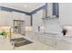 Beautiful kitchen features stainless steel appliances, granite countertops, modern cabinetry, and a stylish backsplash at 23590 Copperleaf Dr, Venice, FL 34293