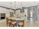 Open concept kitchen featuring a center island with pendant lighting and stainless steel appliances at 23590 Copperleaf Dr, Venice, FL 34293