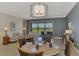 Living and dining area with neutral tones and sliding glass doors that offer views of the outdoor living space at 23590 Copperleaf Dr, Venice, FL 34293