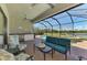 Covered patio with an outdoor kitchen, a seating area, and a beautiful pool view at 23590 Copperleaf Dr, Venice, FL 34293