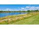 Scenic view of a large pond with lush green surroundings at 23590 Copperleaf Dr, Venice, FL 34293