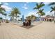 Palm tree lined pool view with lounge seating and umbrellas creating a tropical oasis at 23590 Copperleaf Dr, Venice, FL 34293