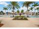 Resort-style pool area with palm trees, umbrellas, and plenty of seating for residents at 23590 Copperleaf Dr, Venice, FL 34293