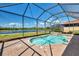 Screened-in pool with spa and beautiful views of the pond at 23590 Copperleaf Dr, Venice, FL 34293