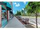 Charming street view featuring shops, benches, sidewalks, and palm trees on a sunny day at 23590 Copperleaf Dr, Venice, FL 34293