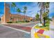 Street view of the Venice Theatre on a sunny day, featuring palm trees and landscaped grounds at 23590 Copperleaf Dr, Venice, FL 34293
