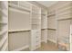 Spacious walk-in closet with built-in shelving, drawers, and hanging rods for optimal organization at 23590 Copperleaf Dr, Venice, FL 34293