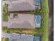 Overhead aerial view of the property featuring a screened-in pool and spa, lush landscaping, and a red property outline at 257 Corelli Dr, Nokomis, FL 34275