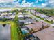 Aerial view of property showcasing the backyard with screen enclosed pool with water feature, lush green yard and red property outline at 257 Corelli Dr, Nokomis, FL 34275