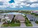 Aerial view of the home showcasing its prime location and proximity to the lake with well-manicured lawn and driveway at 257 Corelli Dr, Nokomis, FL 34275