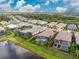 Aerial view of property outlined in red, with pool, lake, and neighborhood at 257 Corelli Dr, Nokomis, FL 34275