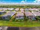Aerial view of the property highlighting its screened-in pool, proximity to the lake and the red property outline at 257 Corelli Dr, Nokomis, FL 34275