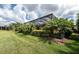 Well-manicured backyard with lush landscaping and a screened-in patio with a pool at 257 Corelli Dr, Nokomis, FL 34275