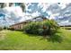 Well-maintained backyard with lush landscaping and a screened-in patio with pool views at 257 Corelli Dr, Nokomis, FL 34275