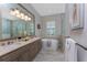 Bright bathroom features a double sink vanity, soaking tub, and walk-in shower at 257 Corelli Dr, Nokomis, FL 34275