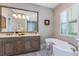 Spacious bathroom with double vanity, soaking tub, and a large mirror at 257 Corelli Dr, Nokomis, FL 34275