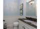 Powder room featuring beadboard paneling and decorative pictures at 257 Corelli Dr, Nokomis, FL 34275