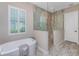 Bright bathroom featuring a soaking tub, large window and a walk-in shower at 257 Corelli Dr, Nokomis, FL 34275