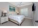 Inviting bedroom features a ceiling fan, plantation shutters, neutral walls, and side tables at 257 Corelli Dr, Nokomis, FL 34275