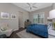 Comfortable bedroom featuring plantation shutters, a ceiling fan, neutral walls, and hardwood floors at 257 Corelli Dr, Nokomis, FL 34275