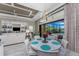 Elegant dining room with chandelier, white chairs, and sliding glass doors to the pool area at 257 Corelli Dr, Nokomis, FL 34275