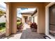 Covered entryway with brick pathway leading to the front door, surrounded by manicured landscaping and lush greenery at 257 Corelli Dr, Nokomis, FL 34275