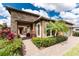 Inviting front entrance with brick pathway, stone accents, lush landscaping and a decorative palm tree at 257 Corelli Dr, Nokomis, FL 34275