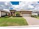 Beautiful front exterior features a well-manicured lawn, landscaped front entrance and a two-car garage with brick paver driveway at 257 Corelli Dr, Nokomis, FL 34275