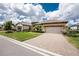 Charming home featuring a two-car garage, stone accents and brick paver driveway in a well-kept neighborhood at 257 Corelli Dr, Nokomis, FL 34275