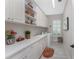 Bright laundry room with ample counter space, storage cabinets, and modern washer/dryer units at 257 Corelli Dr, Nokomis, FL 34275