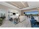 Spacious living room with built-in shelving and tile flooring with pool views at 257 Corelli Dr, Nokomis, FL 34275