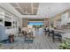 Expansive living room featuring a built-in bookcase, open floor plan, with views of the outdoor pool at 257 Corelli Dr, Nokomis, FL 34275