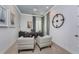 Cozy office features comfortable chairs, sailboat art, a ceiling fan, and natural light at 257 Corelli Dr, Nokomis, FL 34275