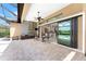 Screened patio with outdoor kitchen and table, large sliding door to indoors, pool view at 257 Corelli Dr, Nokomis, FL 34275