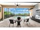 Inviting outdoor patio with built-in grill, screened enclosure, pool and lake views at 257 Corelli Dr, Nokomis, FL 34275