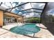 A screened in pool and spa with in-pool seating, and access to the home's patio at 257 Corelli Dr, Nokomis, FL 34275