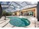 View of the pool, screened-in patio, and outdoor kitchen from the home's exterior at 257 Corelli Dr, Nokomis, FL 34275