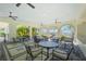 Inviting outdoor seating area with wrought iron tables and chairs overlooking the pool at 257 Corelli Dr, Nokomis, FL 34275