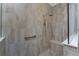 Walk-in shower with stone wall and bench at 257 Corelli Dr, Nokomis, FL 34275
