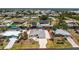 An aerial view of the single-story home showcases the home's layout, landscaping, and waterfront location at 2673 Titania Rd, Englewood, FL 34224