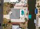 Aerial shot features a stunning pool, canal access, and a well-manicured lawn at 2673 Titania Rd, Englewood, FL 34224