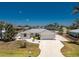 Aerial view of a charming single-story home featuring a long driveway and mature landscaping at 2673 Titania Rd, Englewood, FL 34224