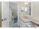 Neutral bathroom featuring a vanity with a framed mirror, and entrance to the office at 2673 Titania Rd, Englewood, FL 34224